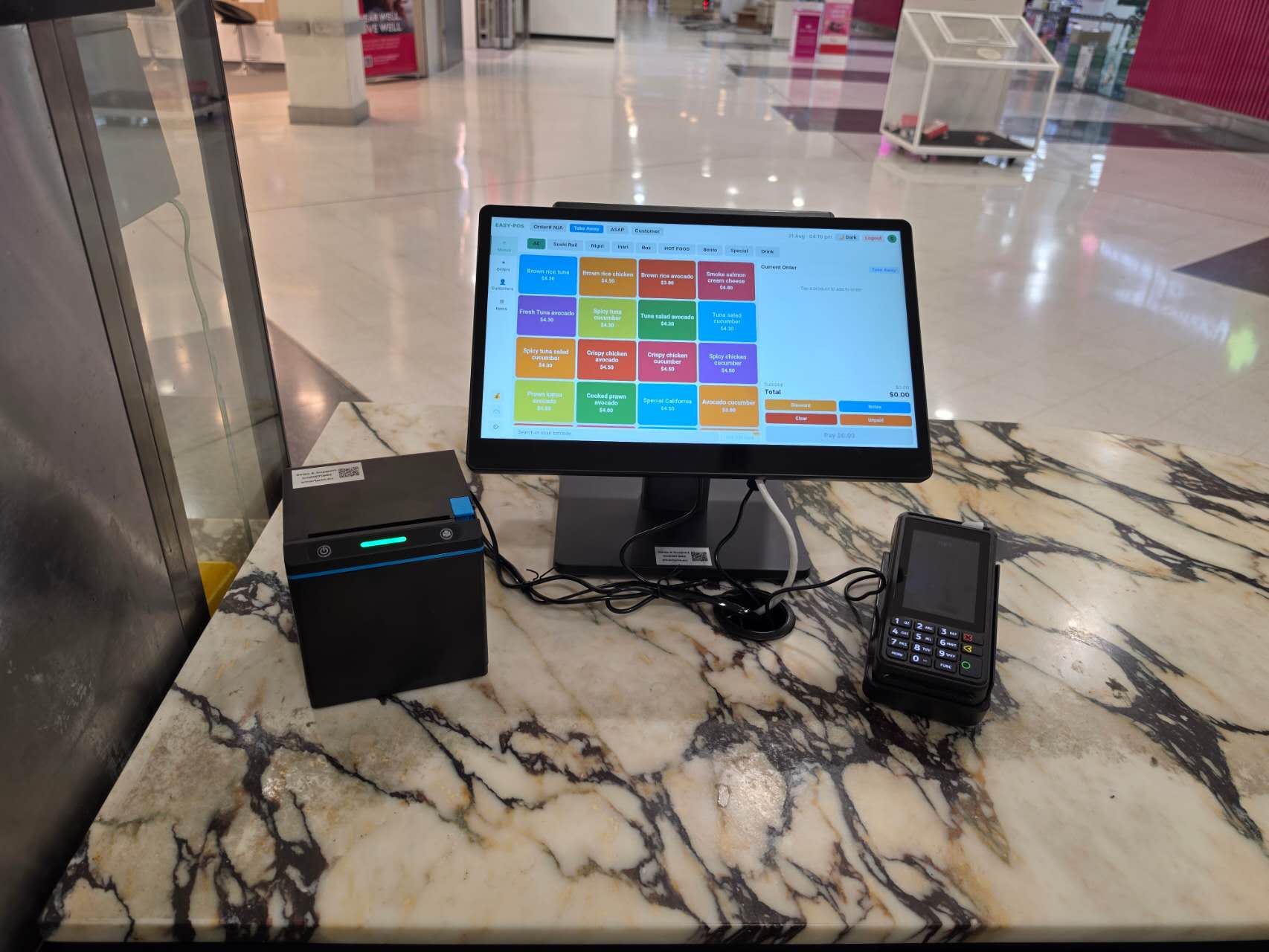 Smart POS, receipt printer and card terminal on the marble counter
