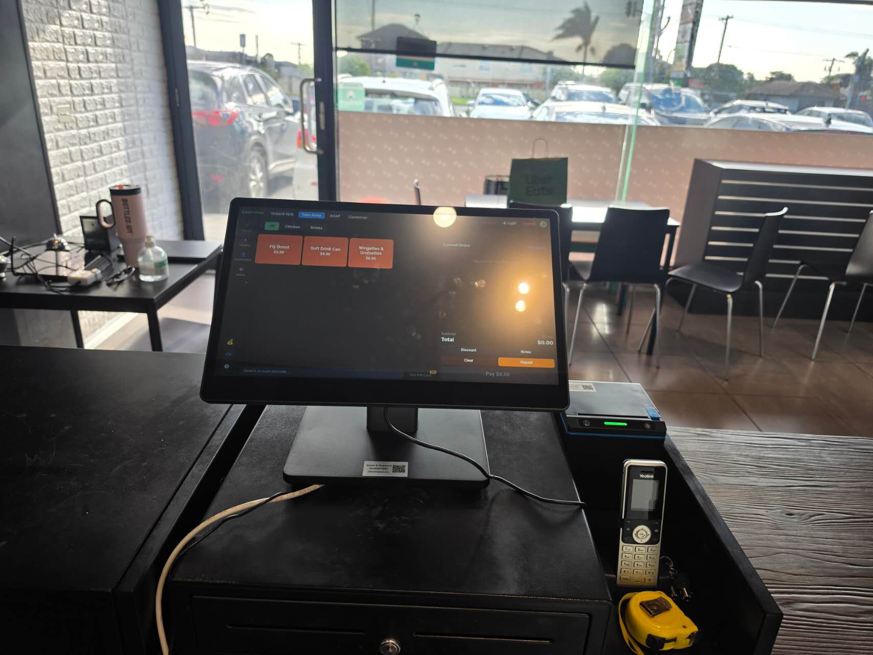 Smart POS on the counter of a Korean chicken shop, dark screen